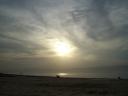 Sun through clouds on beach